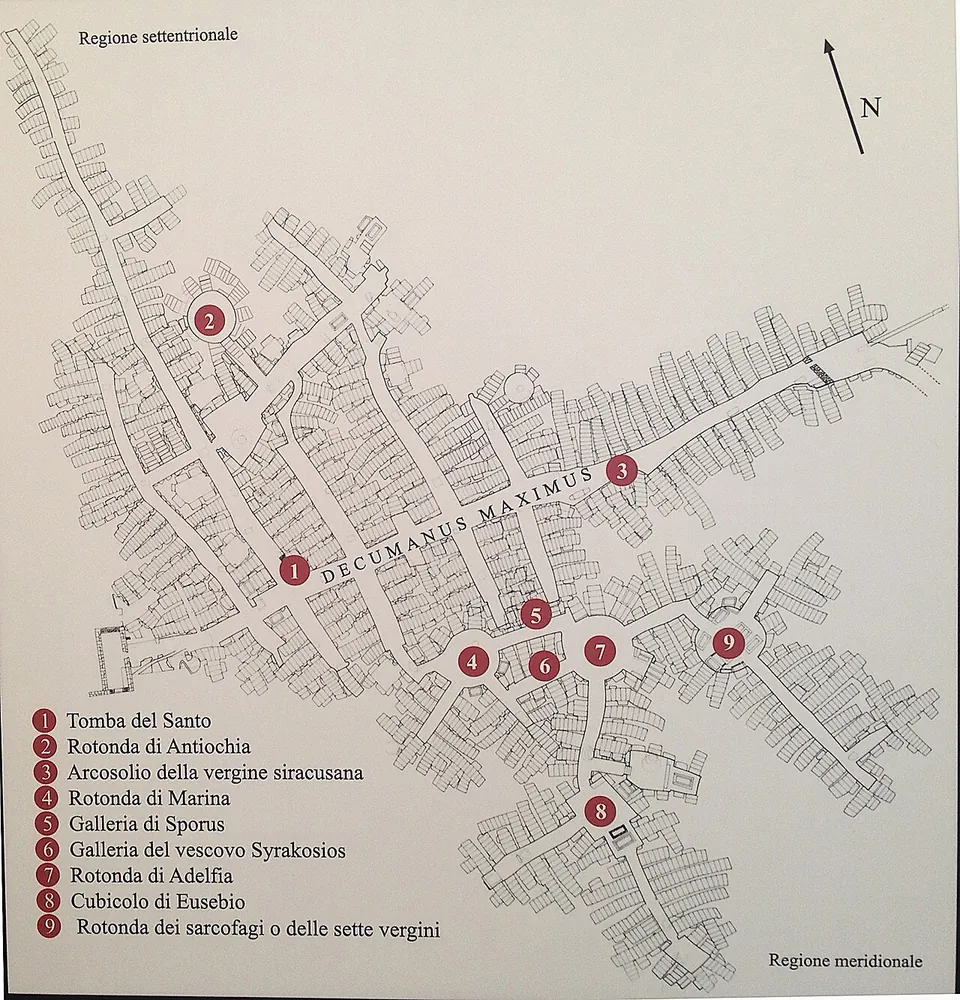 A printed plan of a dense grid of galleries crowded with tomb outlines, crossed by a long main gallery labelled Decumanus Maximus, with nine numbered points and a legend naming rotundas, galleries and tombs.