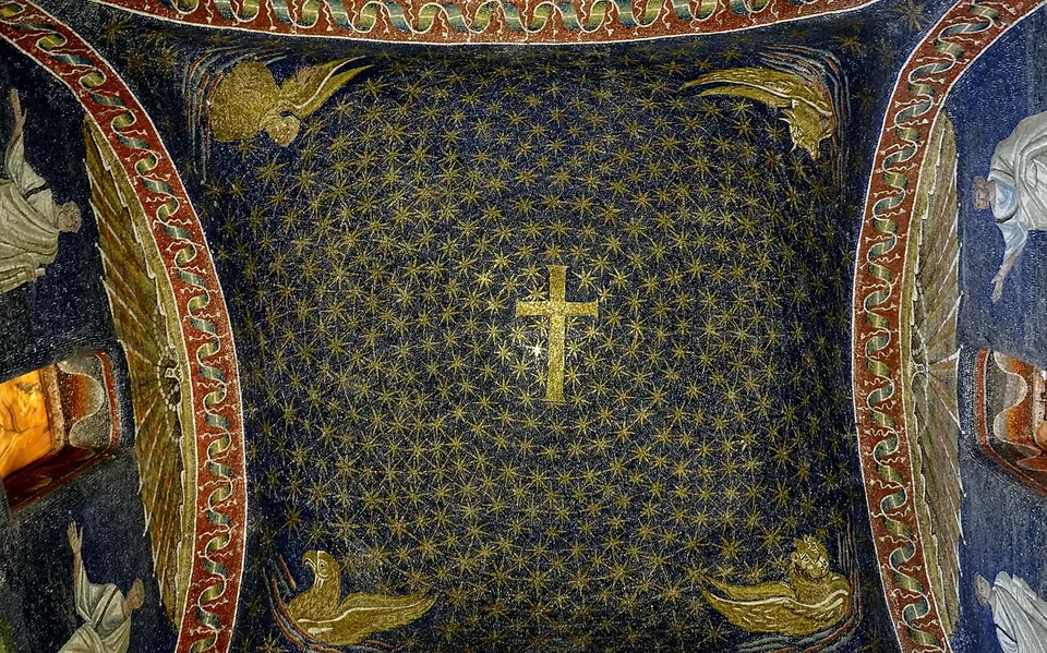 Looking straight up into a dark blue mosaic dome filled with small gold stars, a gold cross at its centre and a gold winged figure in each corner, framed by arches with red and gold borders and standing robed figures at the sides.