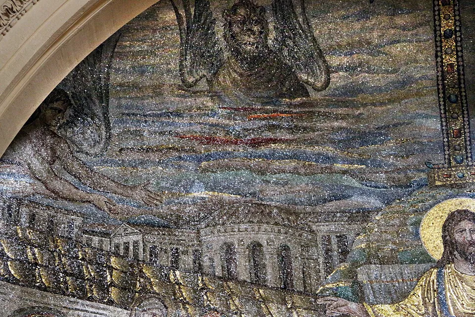 A close view of the upper left of the mosaic, made of small glittering tesserae. Dark winged creatures float in a sky of grey-blue bands streaked with red, above a row of buildings with arched windows and a dome; the edge of the cross and of Christ's halo show at the right.