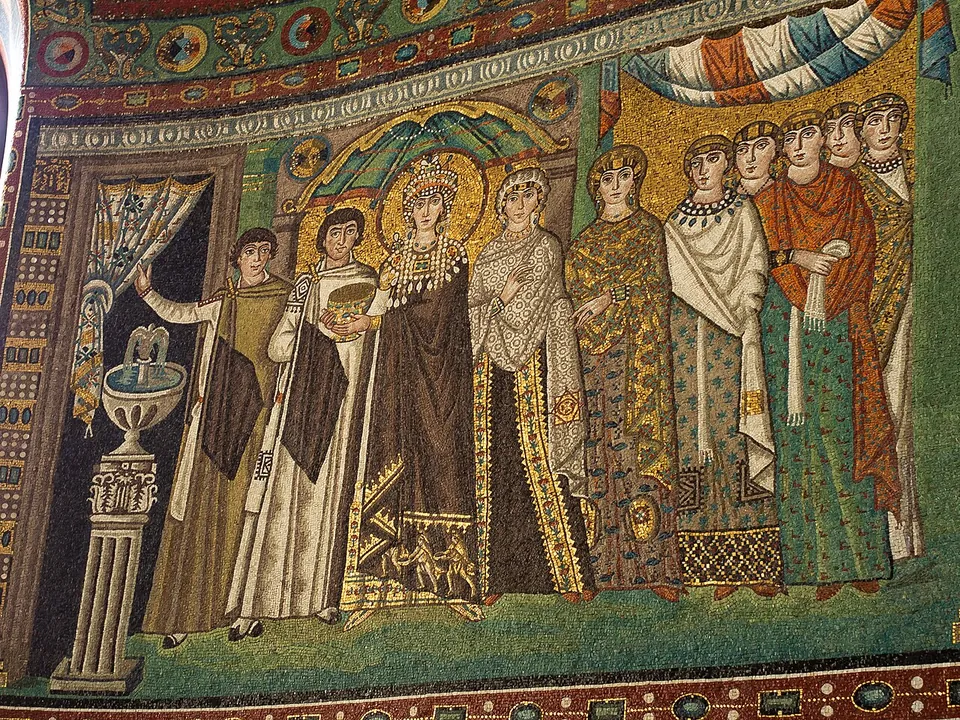A mosaic panel on a gold and green ground. A crowned woman with a halo holds a large golden vessel among attendants; at the left a man lifts a curtain over a doorway beside a fountain on a column, and women in richly patterned robes stand at the right under a striped canopy.