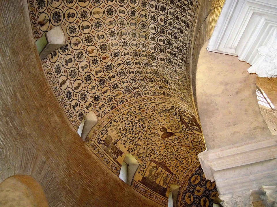 A curving vault covered in mosaic, a lattice of small round medallions holding birds and figures, giving way to a panel of dense scrolling foliage with a framed scene at its edge, small windows set low in the wall.