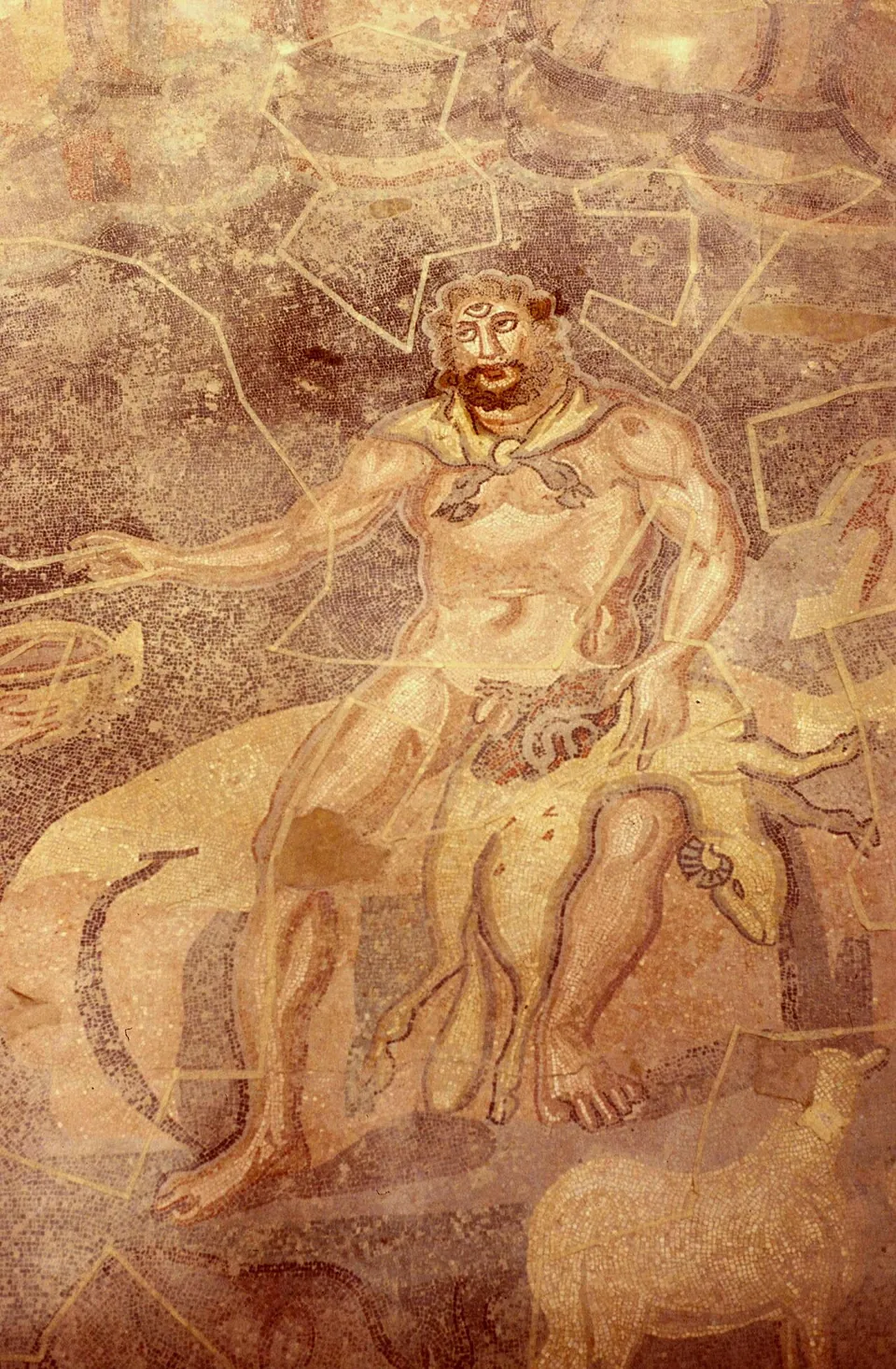 A close view of a mosaic of a seated, bearded giant with three eyes, a slaughtered animal across his lap and a ram at his feet; pale lines run across the surface.
