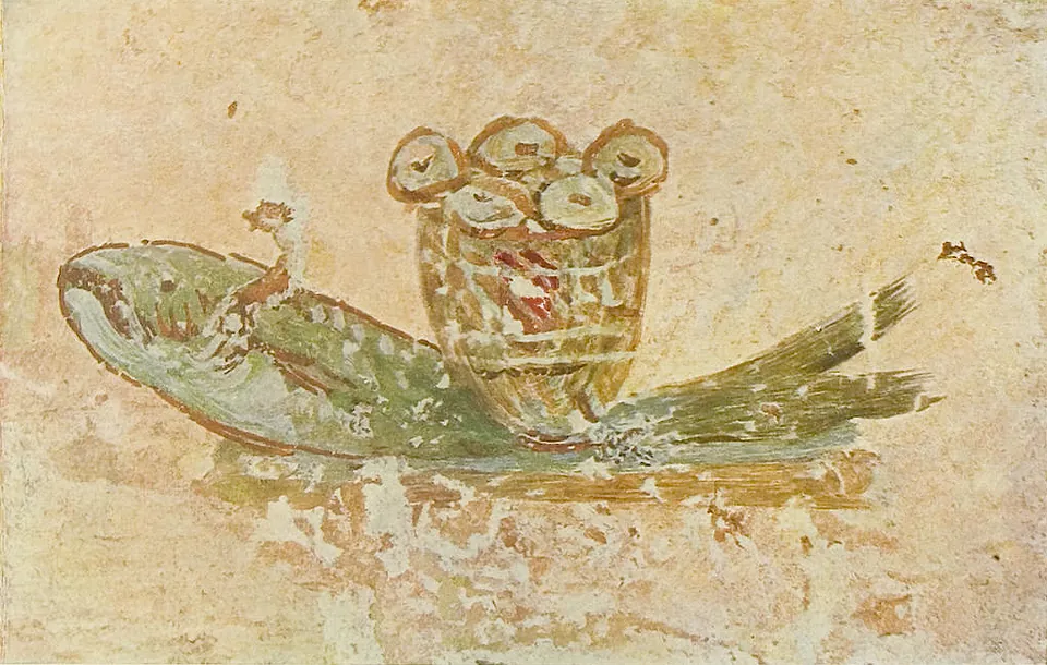 A painting on rough plaster of a large green fish with a wicker basket on its back holding round loaves, the surface cracked and flaking.